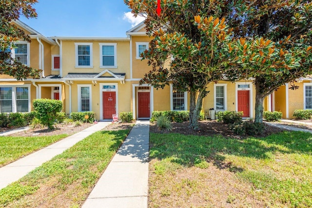 8814 Red Beechwood Ct, Riverview, FL 33578 - view of front facade with stucco siding and a front lawn