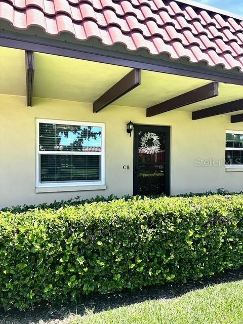 1701 Pinehurst Rd Unit 13C, Dunedin, FL 34698 - entrance to property with a tiled roof and stucco siding