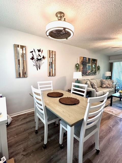 1701 Pinehurst Rd Unit 13C, Dunedin, FL 34698 - dining room with a textured ceiling, dark wood-style flooring, and ceiling fan
