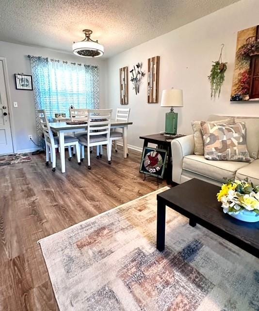 1701 Pinehurst Rd Unit 13C, Dunedin, FL 34698 - dining space featuring wood finished floors and a textured ceiling