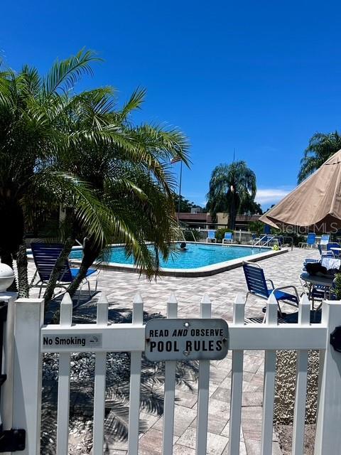1701 Pinehurst Rd Unit 13C, Dunedin, FL 34698 - community pool featuring a patio