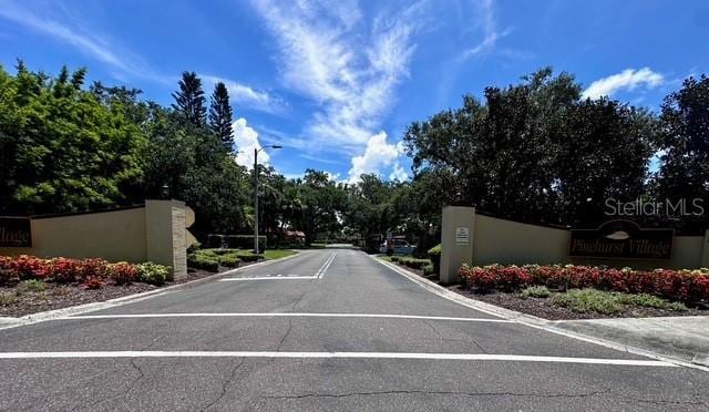 1701 Pinehurst Rd Unit 13C, Dunedin, FL 34698 - view of asphalt street featuring street lights and curbs