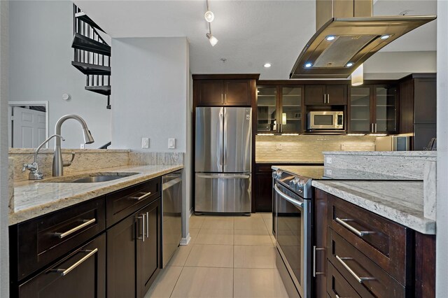 501 Knights Run Ave Unit 1317, Tampa, FL 33602 - kitchen with appliances with stainless steel finishes, exhaust hood, light tile patterned floors, dark brown cabinetry, and light stone counters