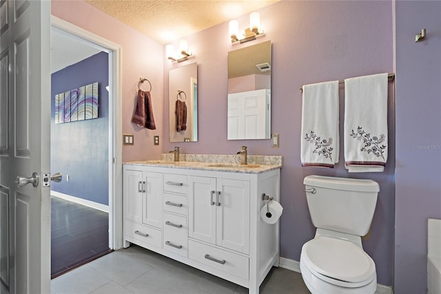 501 Knights Run Ave Unit 1317, Tampa, FL 33602 - full bathroom with double vanity, tile patterned flooring, and a textured ceiling
