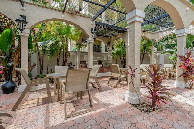 501 Knights Run Ave Unit 1317, Tampa, FL 33602 - view of patio / terrace with outdoor dining area, a pergola, and an outdoor kitchen