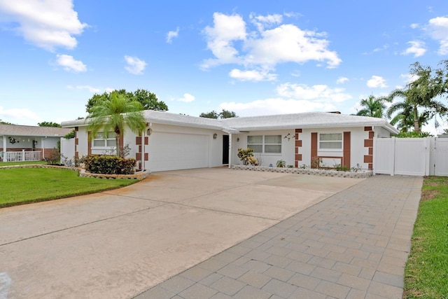 13565 86th Ave, Seminole, FL 33776 - ranch-style house with driveway, an attached garage, a gate, and stucco siding