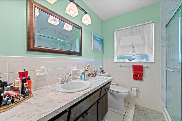 13565 86th Ave, Seminole, FL 33776 - bathroom with vanity, a stall shower, tile walls, tile patterned floors, and a wainscoted wall