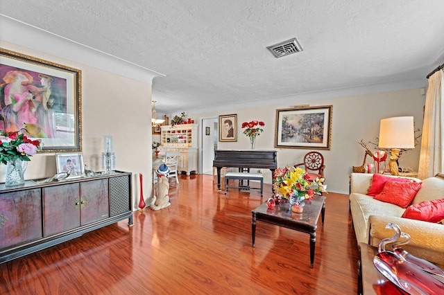13565 86th Ave, Seminole, FL 33776 - living room featuring a textured ceiling and wood finished floors
