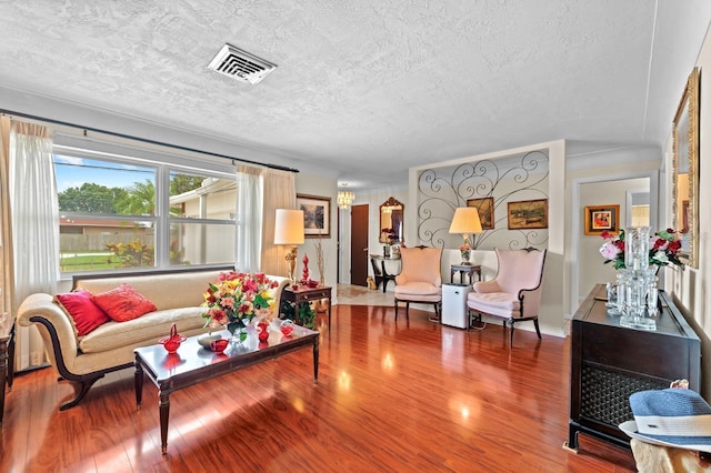 13565 86th Ave, Seminole, FL 33776 - living area with wood finished floors and a textured ceiling