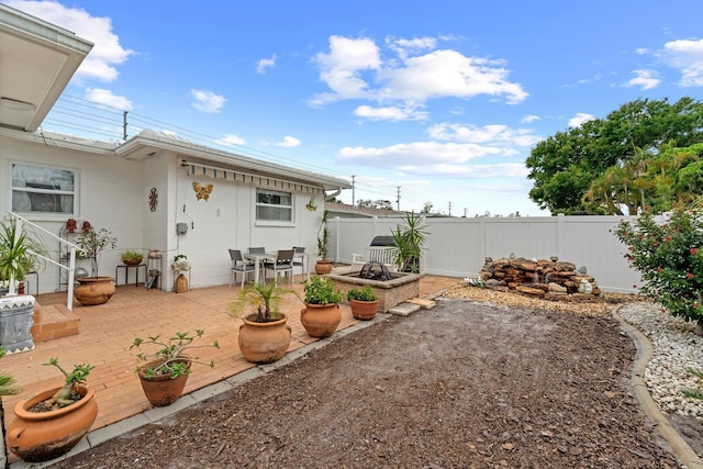 13565 86th Ave, Seminole, FL 33776 - fenced backyard with a fire pit and a patio