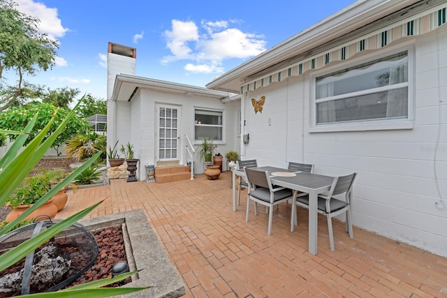 13565 86th Ave, Seminole, FL 33776 - view of patio featuring outdoor dining space and entry steps