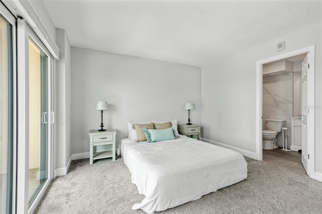 51 Island Way Unit 411, Clearwater Beach, FL 33767 - bedroom featuring carpet, a textured ceiling, and ensuite bath