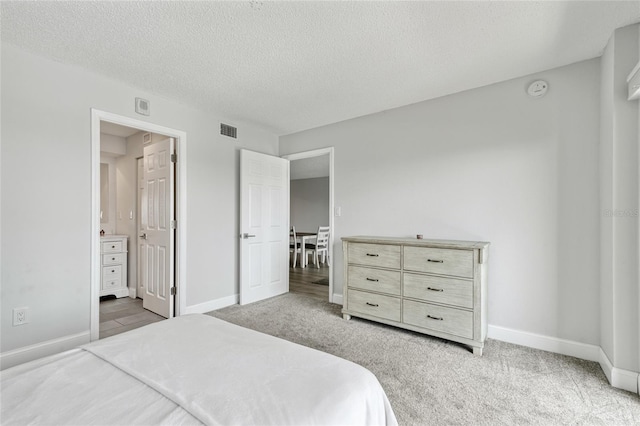51 Island Way Unit 411, Clearwater Beach, FL 33767 - carpeted bedroom with a textured ceiling and ensuite bathroom