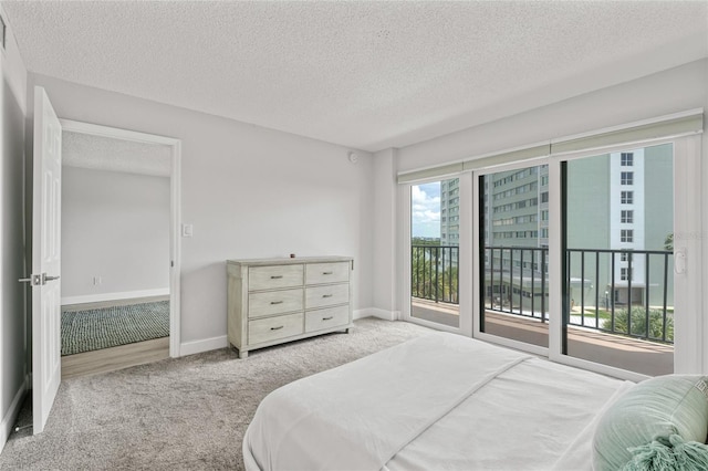 51 Island Way Unit 411, Clearwater Beach, FL 33767 - bedroom with carpet, a textured ceiling, and access to exterior