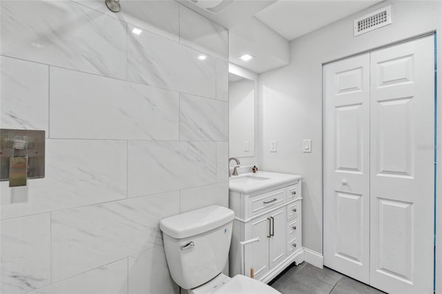 51 Island Way Unit 411, Clearwater Beach, FL 33767 - bathroom featuring vanity, a closet, and tile patterned floors