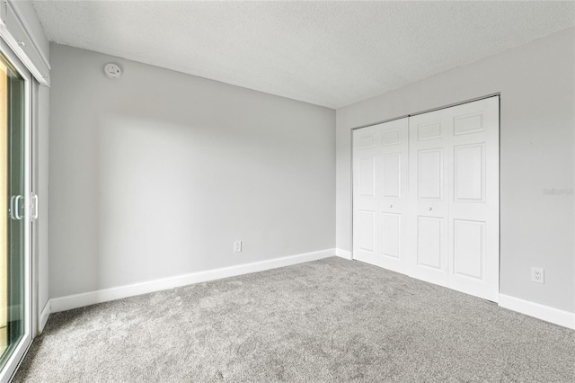 51 Island Way Unit 411, Clearwater Beach, FL 33767 - unfurnished bedroom featuring a textured ceiling, carpet floors, and a closet