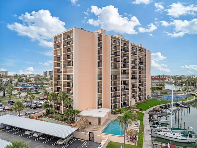 51 Island Way Unit 411, Clearwater Beach, FL 33767 - view of apartment building / complex with a water view and uncovered parking