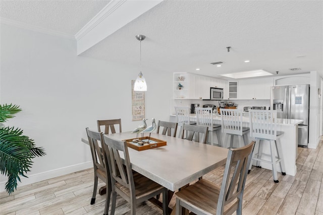 18500 Gulf Blvd Unit 503, Indian Shores, FL 33785 - dining room with a textured ceiling, wood tiled floors, crown molding, and recessed lighting