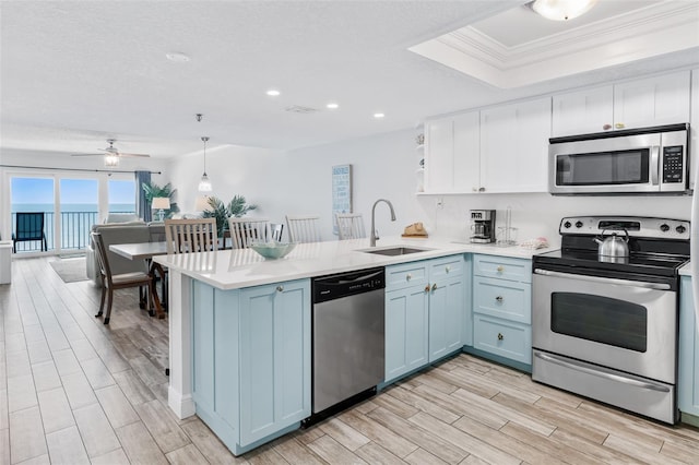 18500 Gulf Blvd Unit 503, Indian Shores, FL 33785 - kitchen featuring appliances with stainless steel finishes, a peninsula, light countertops, light wood-type flooring, and recessed lighting