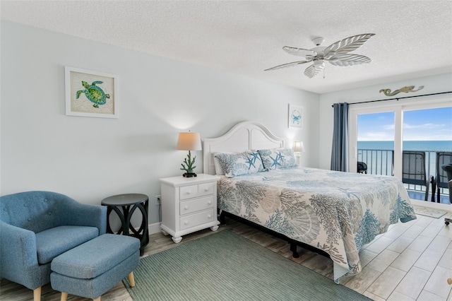 18500 Gulf Blvd Unit 503, Indian Shores, FL 33785 - bedroom with access to exterior, wood finished floors, a textured ceiling, and ceiling fan