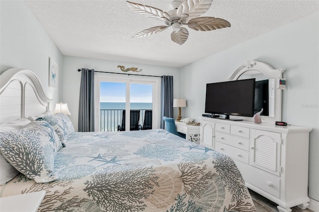 18500 Gulf Blvd Unit 503, Indian Shores, FL 33785 - bedroom with access to exterior, a textured ceiling, and a ceiling fan