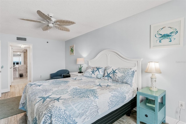 18500 Gulf Blvd Unit 503, Indian Shores, FL 33785 - bedroom with a textured ceiling, wood finished floors, and a ceiling fan