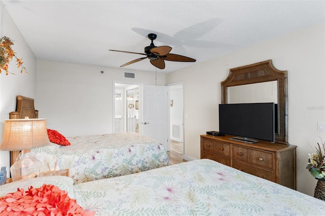18500 Gulf Blvd Unit 503, Indian Shores, FL 33785 - bedroom with ensuite bath, wood finished floors, and ceiling fan