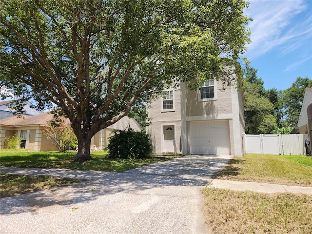 4009 Forecast Dr, Brandon, FL 33511 - view of front of home featuring a garage, driveway, stucco siding, and a gate