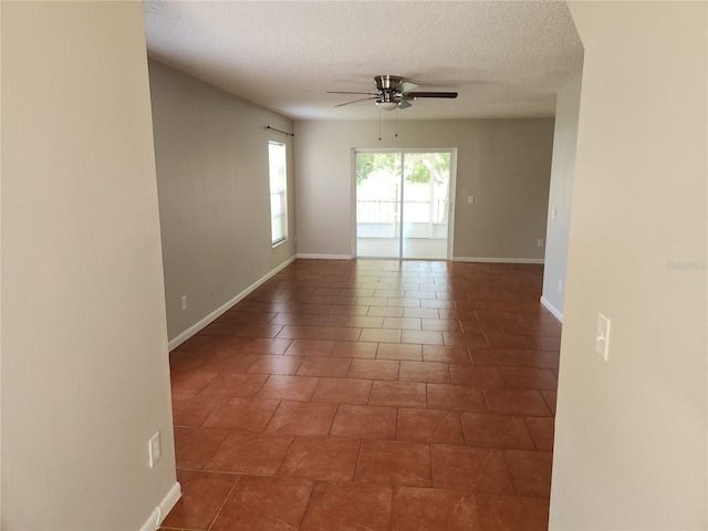 4009 Forecast Dr, Brandon, FL 33511 - empty room with a ceiling fan, a textured ceiling, and dark tile patterned flooring