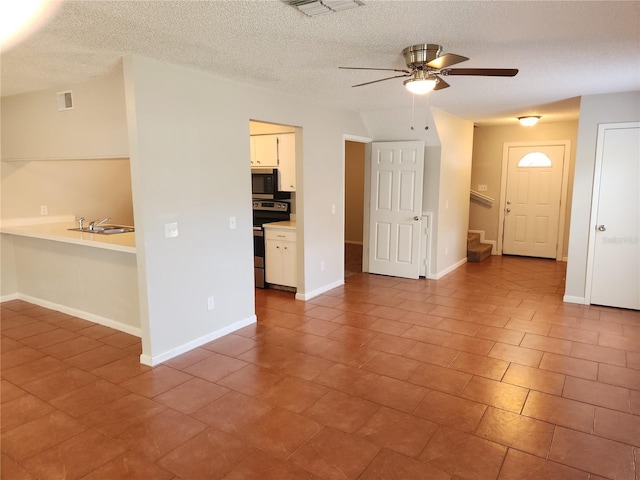 4009 Forecast Dr, Brandon, FL 33511 - unfurnished living room featuring a ceiling fan, stairs, a textured ceiling, and tile patterned floors