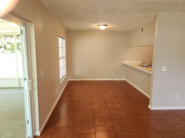 4009 Forecast Dr, Brandon, FL 33511 - unfurnished dining area with a textured ceiling and dark tile patterned flooring