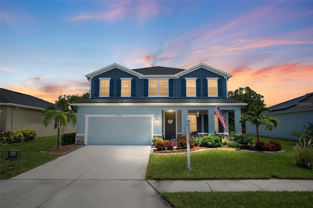 10618 Daybreak Gln, Parrish, FL 34219 - traditional-style house with driveway, a garage, a front lawn, and board and batten siding