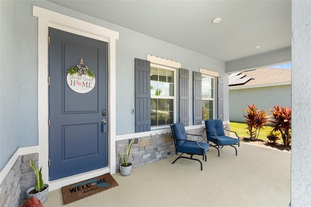 10618 Daybreak Gln, Parrish, FL 34219 - doorway to property with a porch and stucco siding