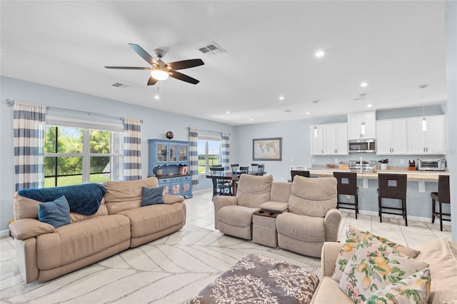 10618 Daybreak Gln, Parrish, FL 34219 - living room featuring a ceiling fan, light tile patterned floors, and recessed lighting