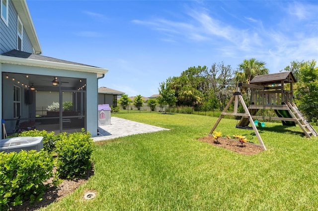 10618 Daybreak Gln, Parrish, FL 34219 - fenced backyard featuring a patio area, a playground, a ceiling fan, and a sunroom