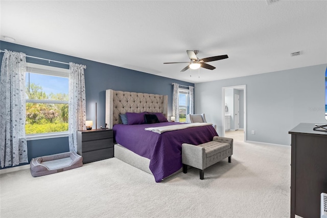 10618 Daybreak Gln, Parrish, FL 34219 - bedroom with light carpet, a ceiling fan, and connected bathroom