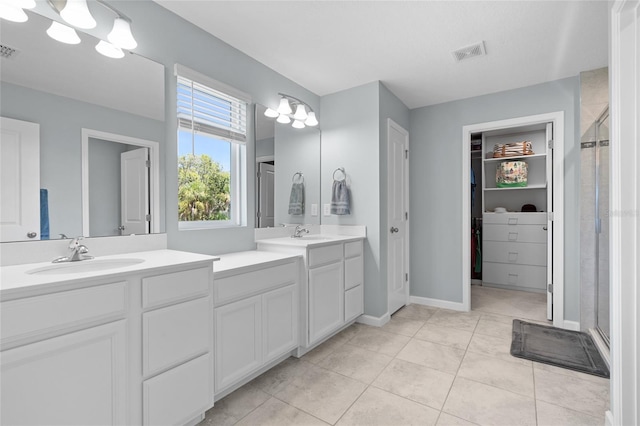 10618 Daybreak Gln, Parrish, FL 34219 - bathroom with a shower stall, vanity, a walk in closet, and tile patterned flooring