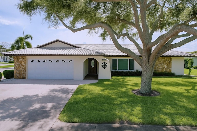 11141 Carla Dr, Largo, FL 33774 - view of front facade featuring a garage, stone siding, driveway, a front yard, and a tiled roof