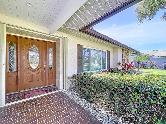 11141 Carla Dr, Largo, FL 33774 - doorway to property featuring stucco siding