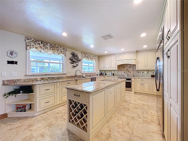11141 Carla Dr, Largo, FL 33774 - kitchen with oven, light stone counters, a center island, backsplash, and black electric cooktop