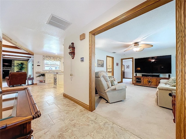 11141 Carla Dr, Largo, FL 33774 - living area featuring a textured ceiling, stone tile flooring, and ceiling fan