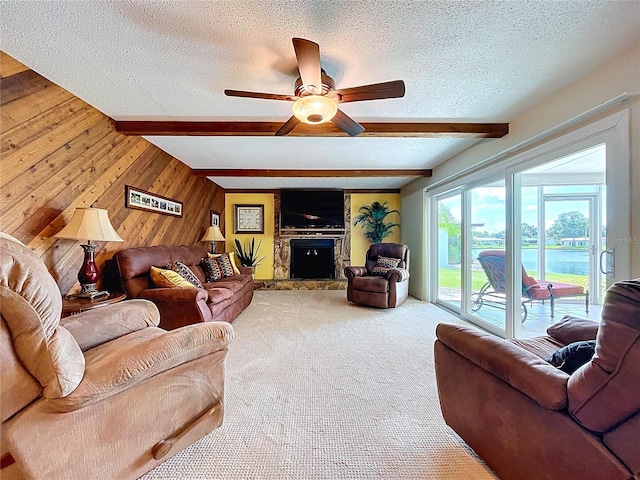 11141 Carla Dr, Largo, FL 33774 - living room featuring a textured ceiling, beamed ceiling, wooden walls, ceiling fan, and carpet