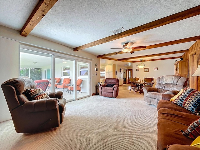 11141 Carla Dr, Largo, FL 33774 - living room with light carpet, beamed ceiling, a ceiling fan, and a textured ceiling