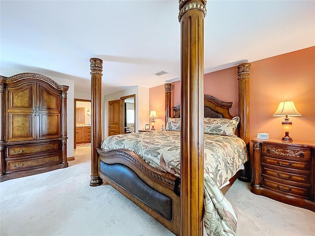 11141 Carla Dr, Largo, FL 33774 - bedroom with light carpet, ornate columns, and connected bathroom
