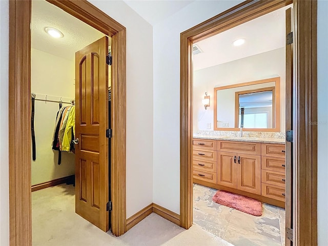 11141 Carla Dr, Largo, FL 33774 - bathroom featuring vanity and a spacious closet