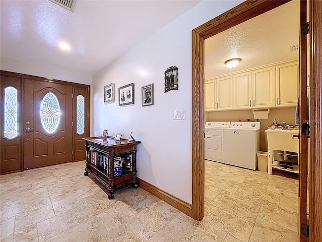 11141 Carla Dr, Largo, FL 33774 - foyer entrance with washer and clothes dryer and stone tile floors