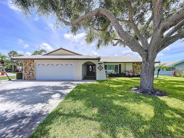 11141 Carla Dr, Largo, FL 33774 - ranch-style house with an attached garage, driveway, a front yard, stucco siding, and a tiled roof