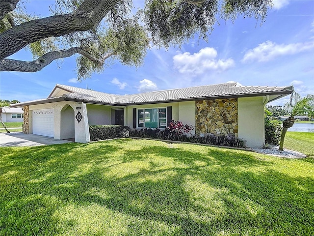 11141 Carla Dr, Largo, FL 33774 - ranch-style home featuring stucco siding, a garage, a tiled roof, and a front lawn