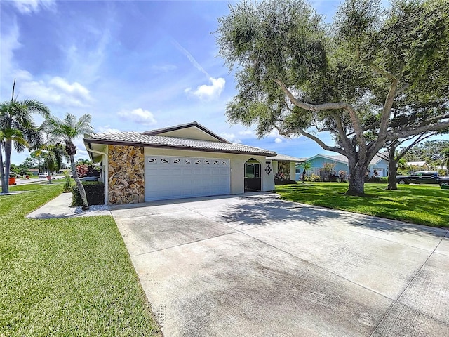 11141 Carla Dr, Largo, FL 33774 - single story home featuring concrete driveway, a front yard, an attached garage, a tile roof, and stone siding