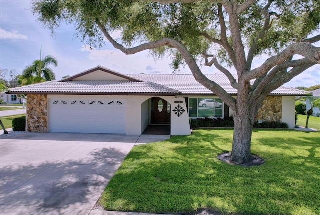 11141 Carla Dr, Largo, FL 33774 - ranch-style house with a tiled roof, a garage, driveway, stone siding, and a front lawn